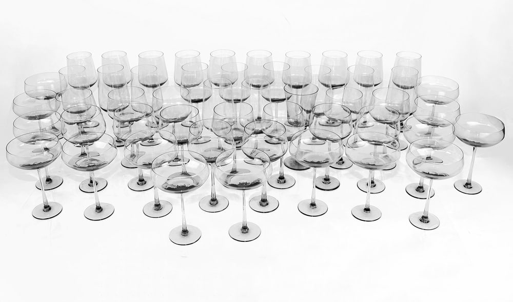 Calvin Klein Group of Glass Stemware (40+): 40+ pieces of Calvin Klein stemware in clear to green glass, including red wine, white wine and water glasses and champagne saucers. Provenance: From the Collection of renowned architect and designer