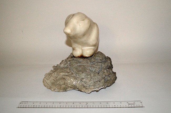 Marble Sculpture of a Polar Bear: Full-length depiction of a polar bear perched on top of an irregular aggregate base. Overall: 11 1/2" W x 11" D x 13" H. Some scuffs and scratches.