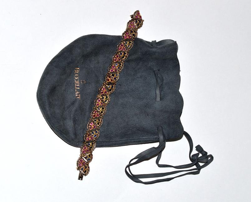 Buccellati 18k Gold, Ruby & Sapphire Bracelet: The tri-color flexible bracelet mounted with 42 round sapphires (2.52 ct) and 42 round rubies (2.52 ct). 30.41 grams of 18k gold. 19.6 dwt overall.