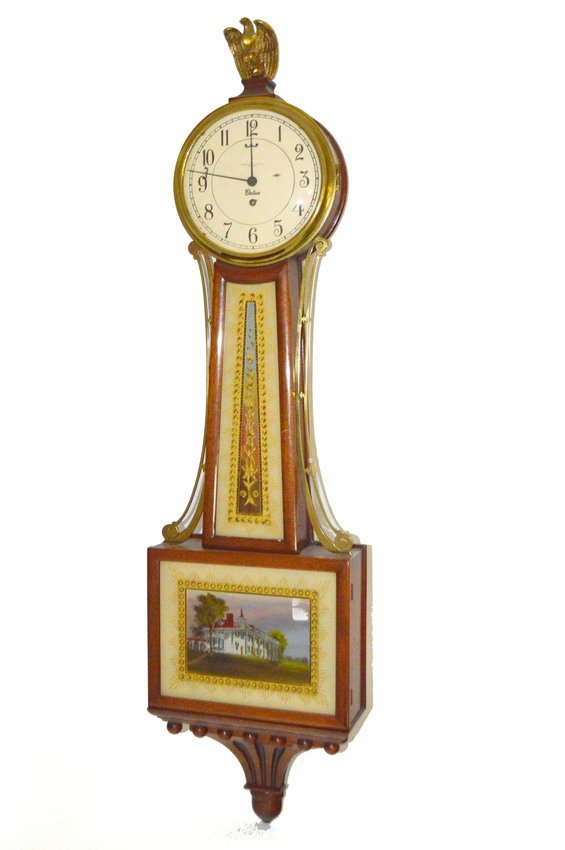 Eglomisé Banjo Clock: Mahogany cased banjo clock by Chelsea. Eagle finial retailed by Abercrombie & Fitch, New York. 34 1/4" x 10 1/4".
