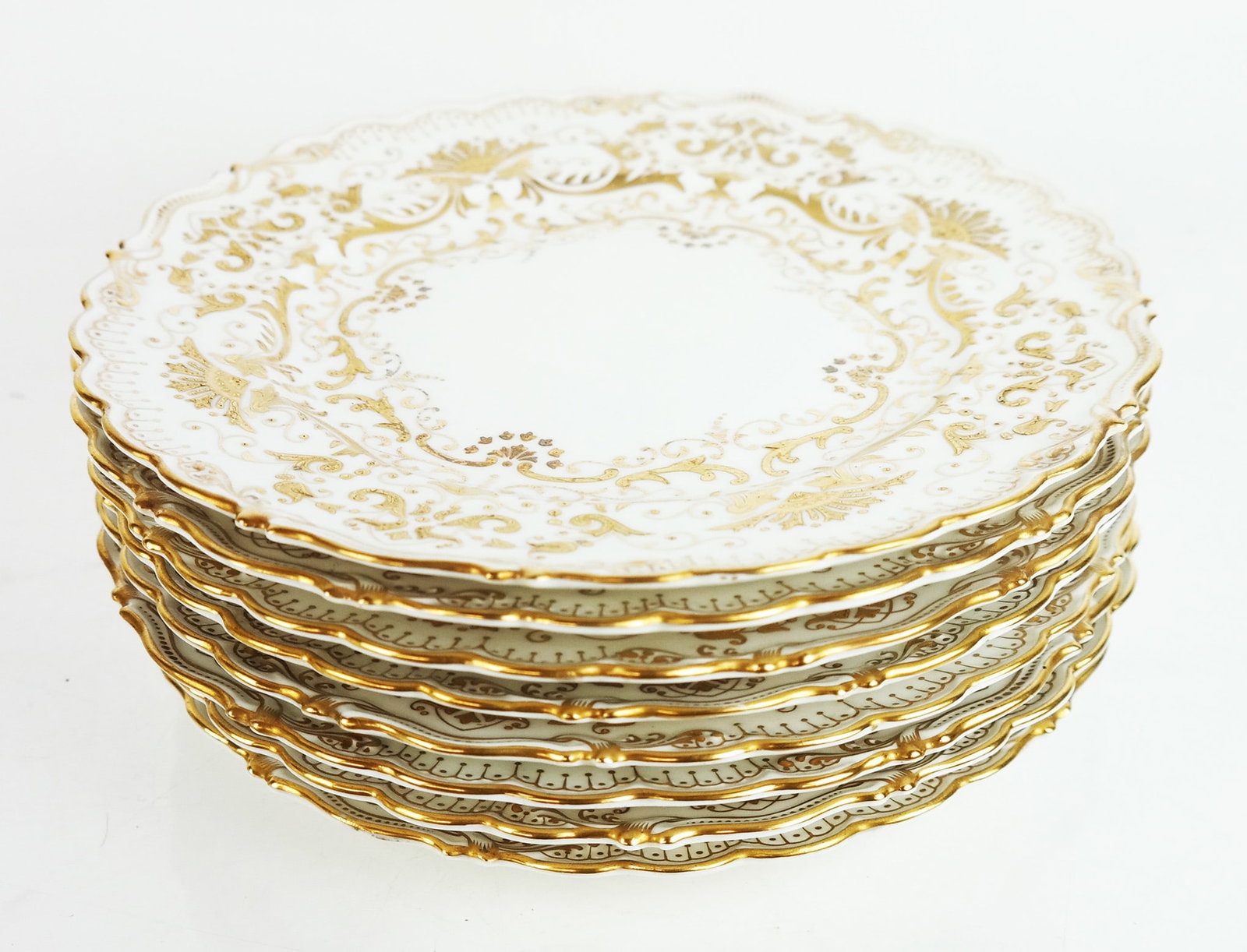 Set of 8 Coalport Place Plates: Set of eight (8) Coalport place plates with allover gilt encrusted scroll designs and scalloped borders, in pattern #2681. [10" Diam.].