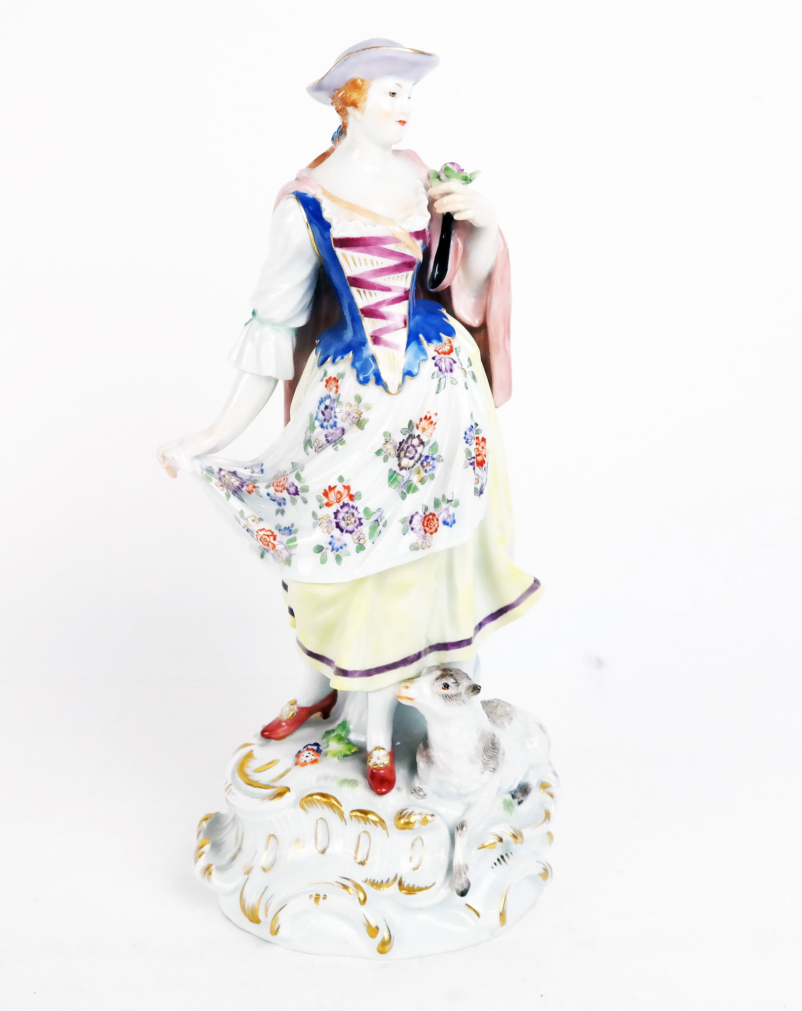 Meissen Figure of a Woman: Meissen figure of a woman in a dress with a lamb, on scrolling self base. [10" H].