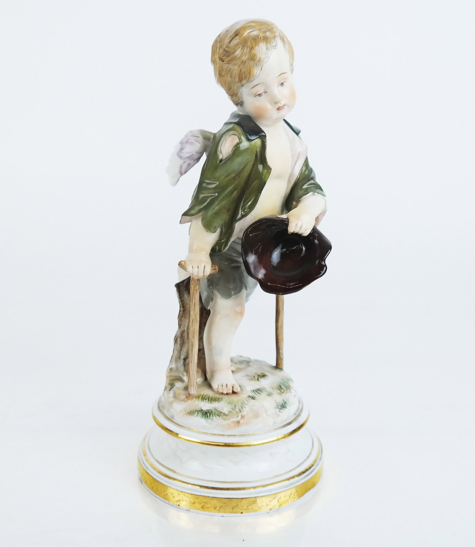 Meissen Figure of a Young Angel: Meissen porcelain figure of an urchin angel on crutches. [9" H].