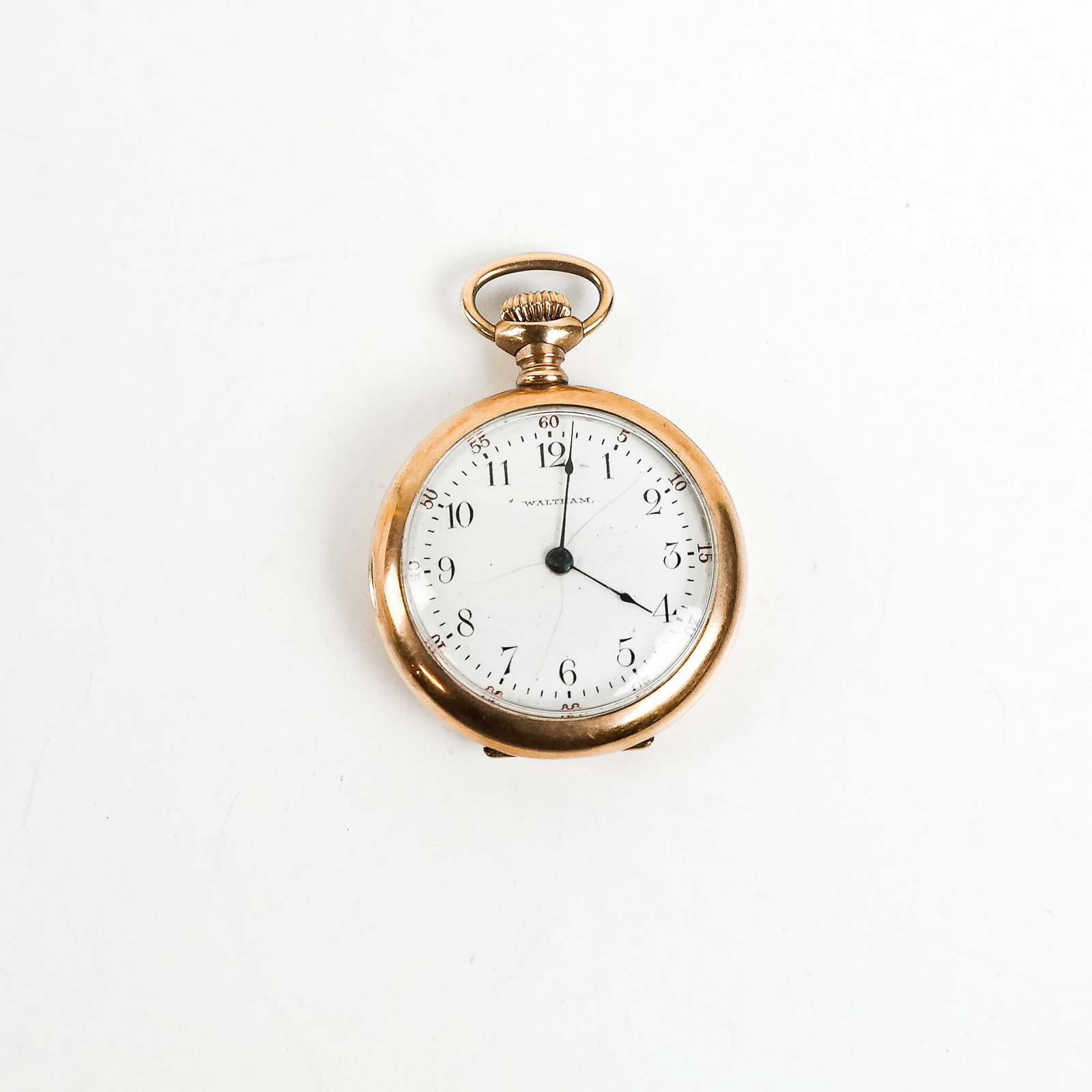 14K Gold Ladies Waltham Pocket Watch: 14K yellow gold ladies' pocket watch, the face imprinted "Waltham" and bearing Arabic numerals. [2 7/8" H x 1 5/16" W x 7/16" D]. (Total weight: 19.17 dwt.). Hairline cracks to face plate enamel; move