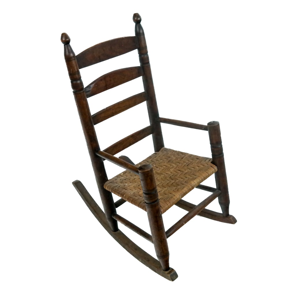 Antique American Child's Rocking Chair: Antique American child's rocking chair, early 20th century, with carved posts and woven seat. [19 1/2" H x 16" W x 24" D].