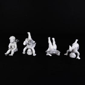 Group of Four Porcelain Cherub Figures