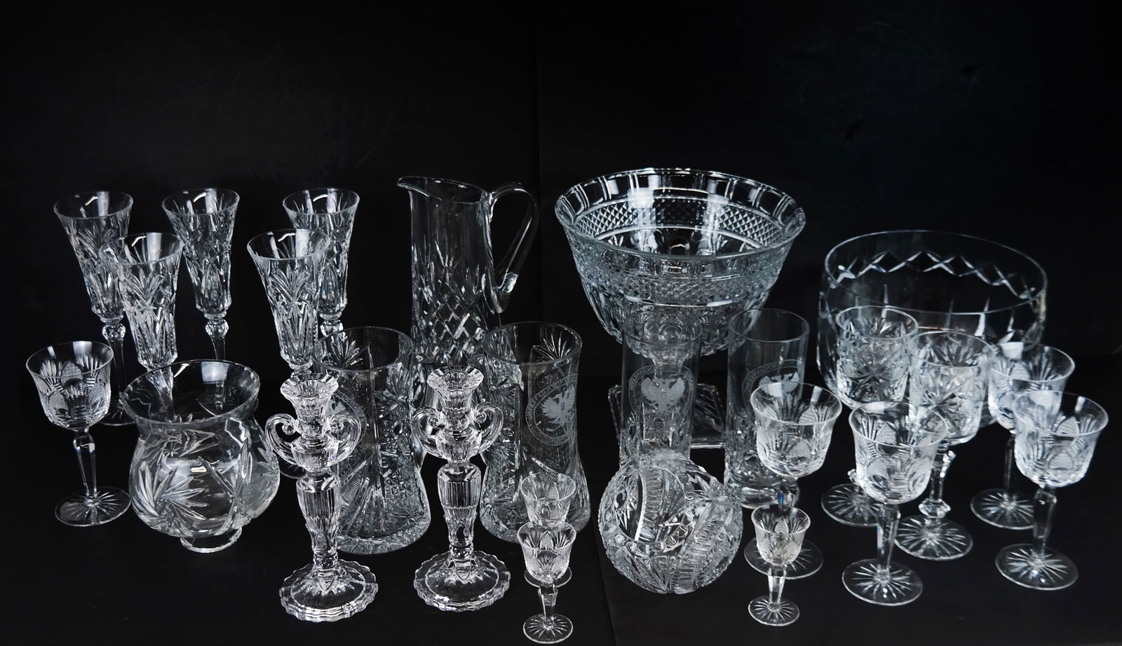 Assembled Cut Crystal Barware (26 Pcs): Assembled group of cut crystal barware, comprising various items and in various patterns, including Russian armorial cocktail pitchers and mixing glasses, cut glass punch bowls, goblets, liqueur glass