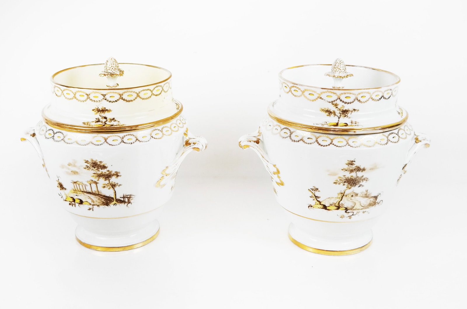 Pair of Paris Porcelain Wine Coolers: Pair of Paris porcelain lidded wine coolers, late 19th or early 20th century, of cylindrical form, the white bodies decorated with yellow and gold wreathes and landscapes, and lids with strawberry fin