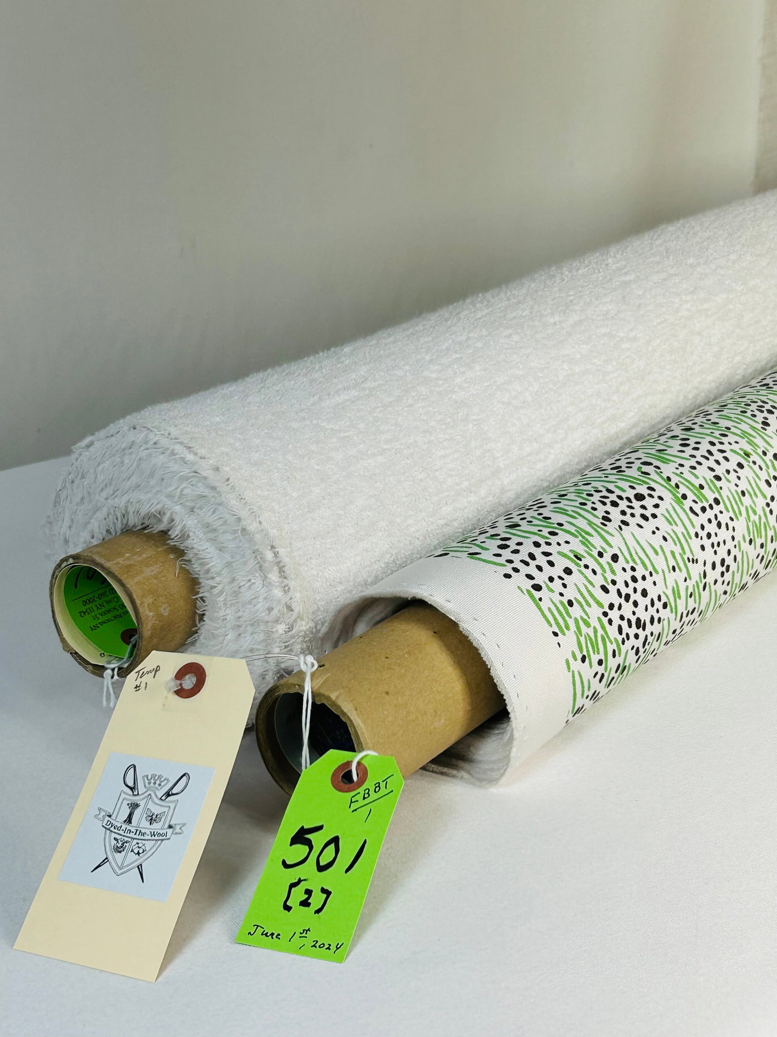 Quadrille and Sunbrella In/Outdoor Fabrics: 1) 5 yards of Quadrille's "Trilby" printed grass and pebble design in green and brown on a white ground, 52" wide. Design repeats of 6 1/4" vertical by 6 1/2" horizontal. Best for upholstery or pillow