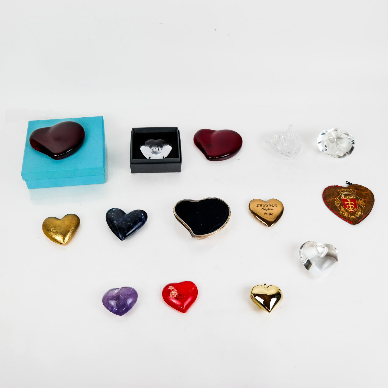 Group of Heart Trinkets (15+): Group of more than fifteen (15+) heart trinkets, of various materials, including glass, metal and stone, by makers such as Elsa Perretti for Tiffany, Waterford, Steuben and Stanger. Provenance: From t