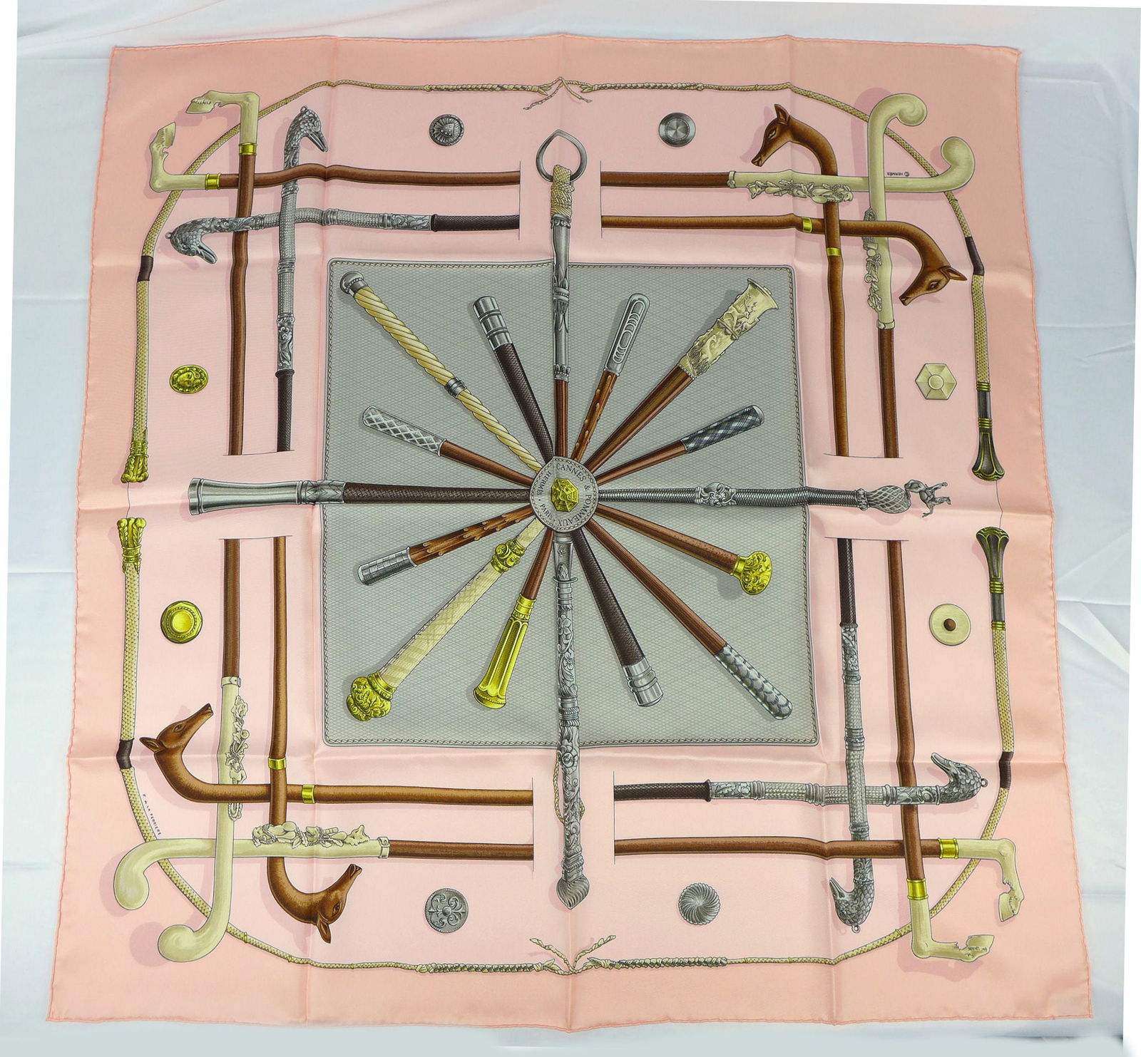 Vintage Hermes Paris Silk Scarf "Cannes et Pommeaux" with box: This is a classic 90cm Carre Hermes Silk Scarf made in Paris dating from the late 80's or 90's. Titled "Cannes et Pommeaux" and is decorated with a display of antique canes and cane handles on pink fi