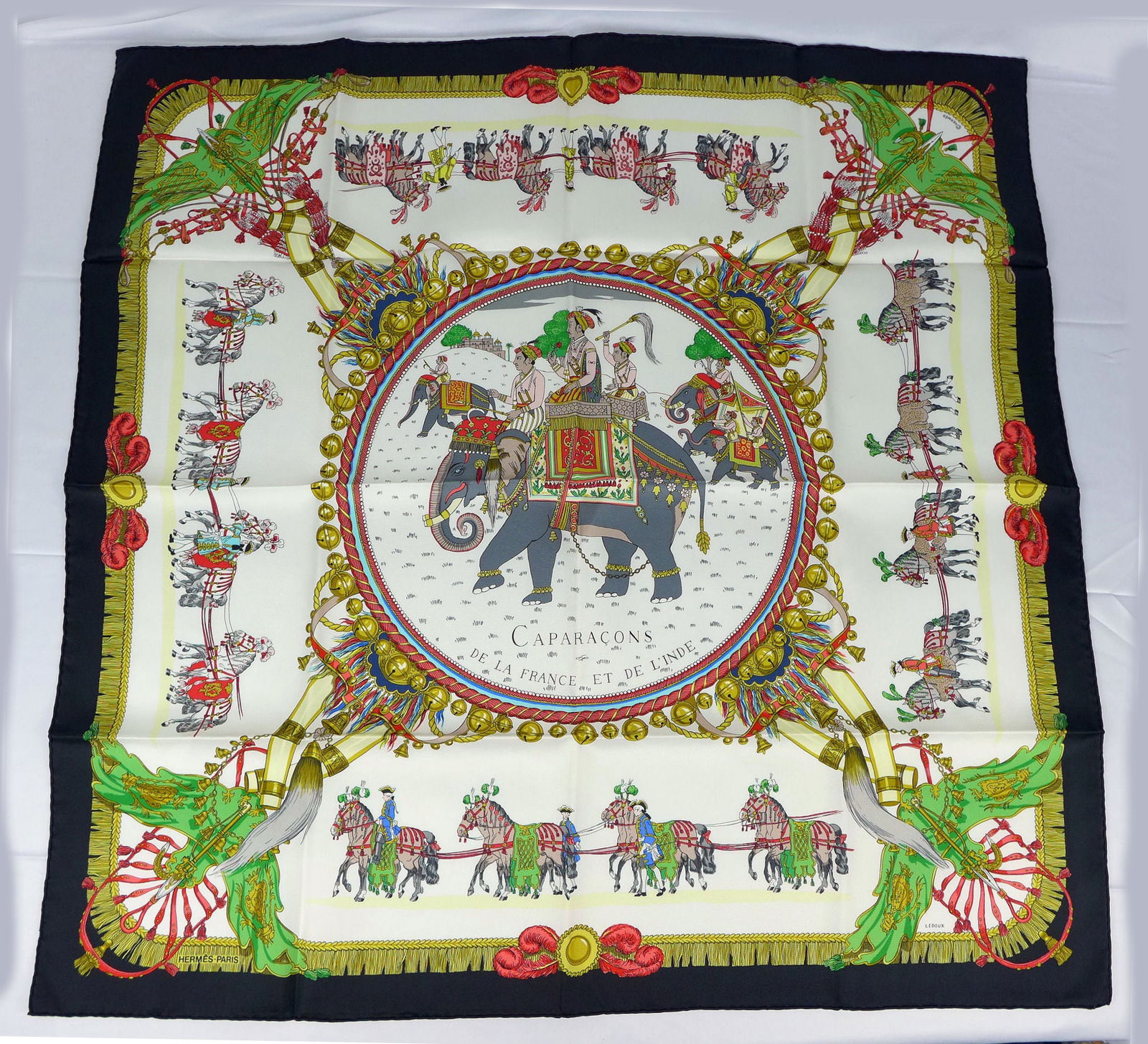 Vintage Hermes Paris Silk Scarf "Caparacons" with box: This is a classic 90cm Carre Hermes Silk Scarf made in Paris dating from the later 80's or 90's. Titled "Caparacons" and is decorated with a large circular center panel with an elephant and riders fro