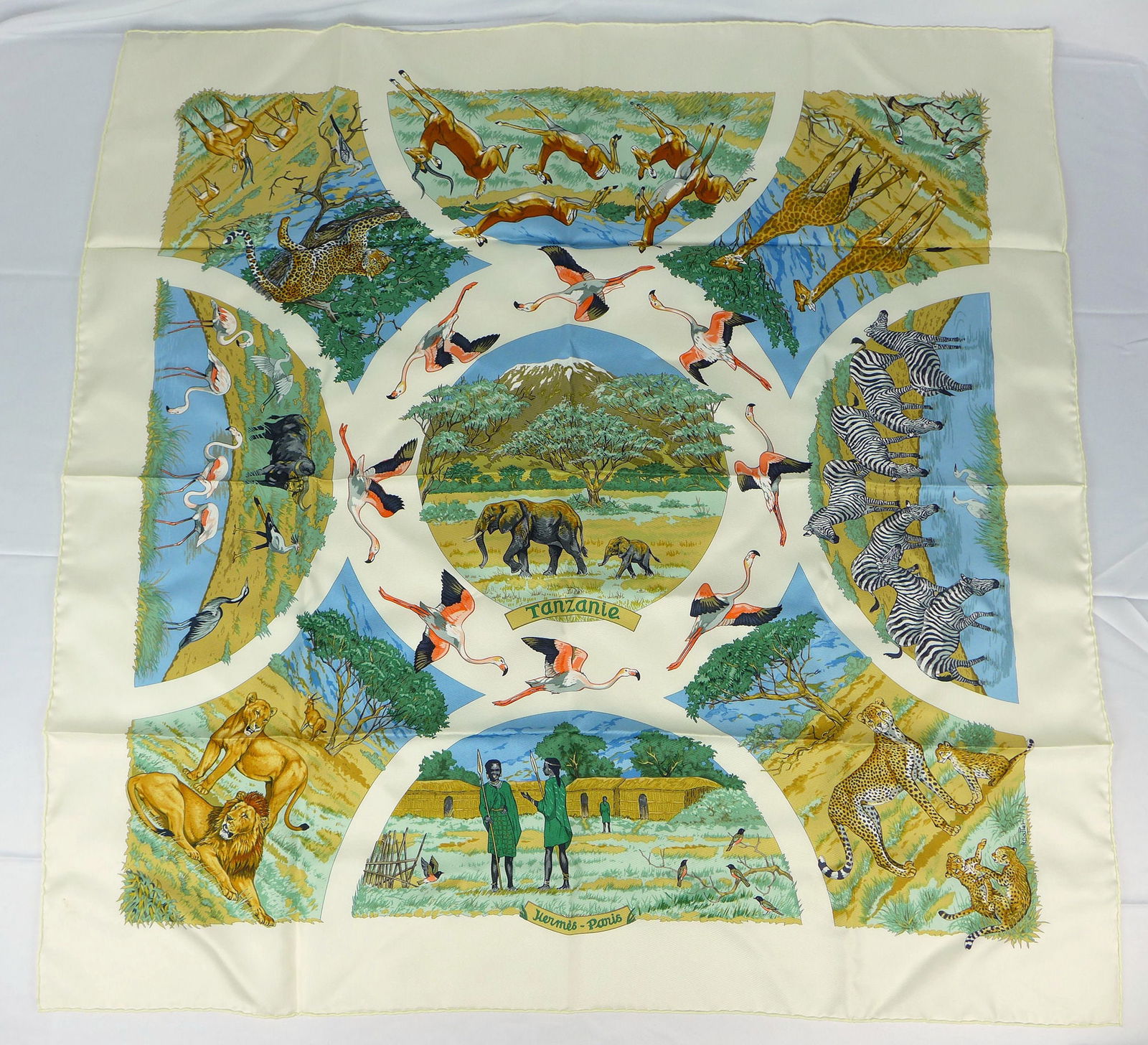 Vintage Hermes Paris Silk Scarf "Tanzanie" with box: This is a classic 90cm Carre Hermes Silk Scarf made in Paris dating from the later 80's or 90's. Titled "Tanzanie" and is decorated with a large group of scenes of animals and people in Tanzania Afric