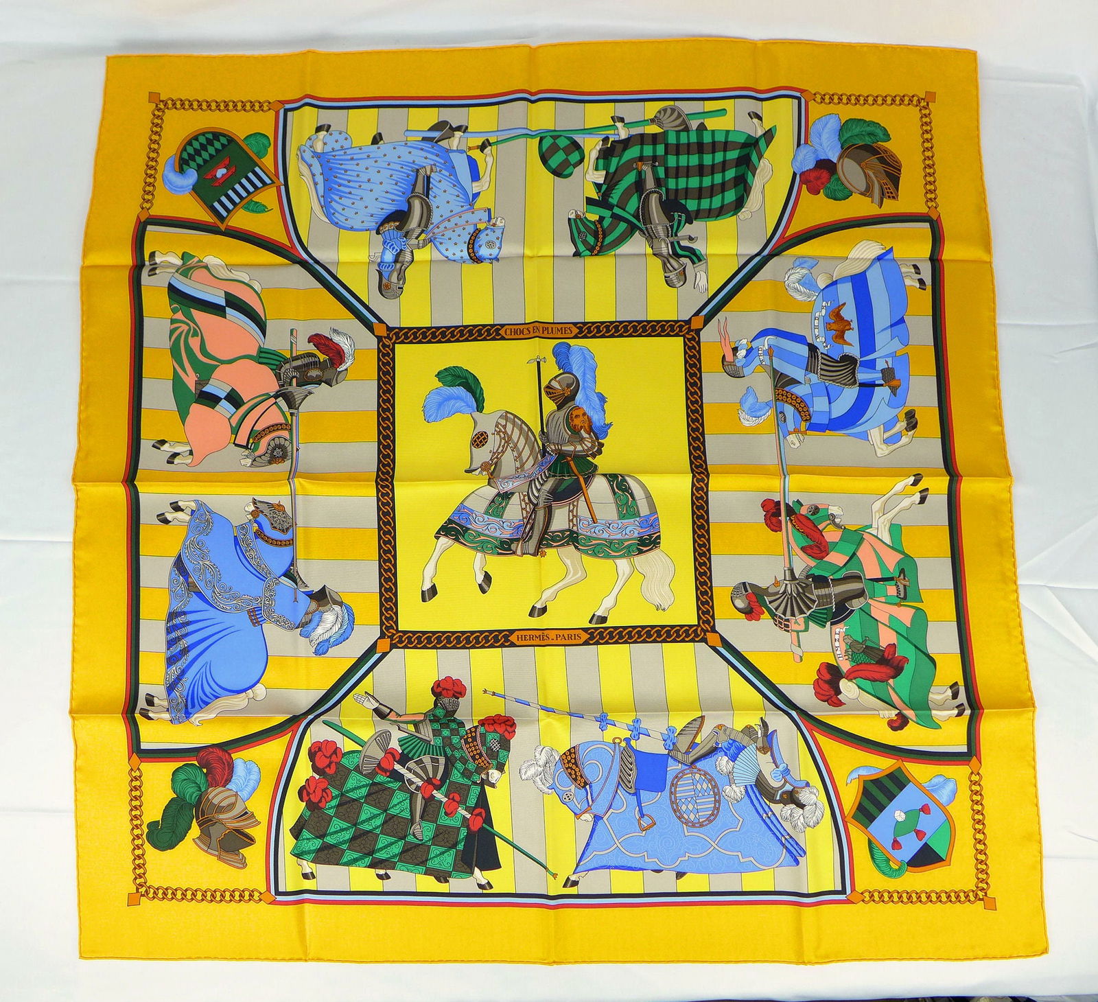 Vintage Hermes Paris Silk Scarf "Chocs en Plumes" with box: This is a classic 90cm Carre Hermes Silk Scarf made in Paris dating from the late 80's or 90's. Titled "Chocs en Plumes" and is decorated with Armored Knights and horses in competition. It was Designe