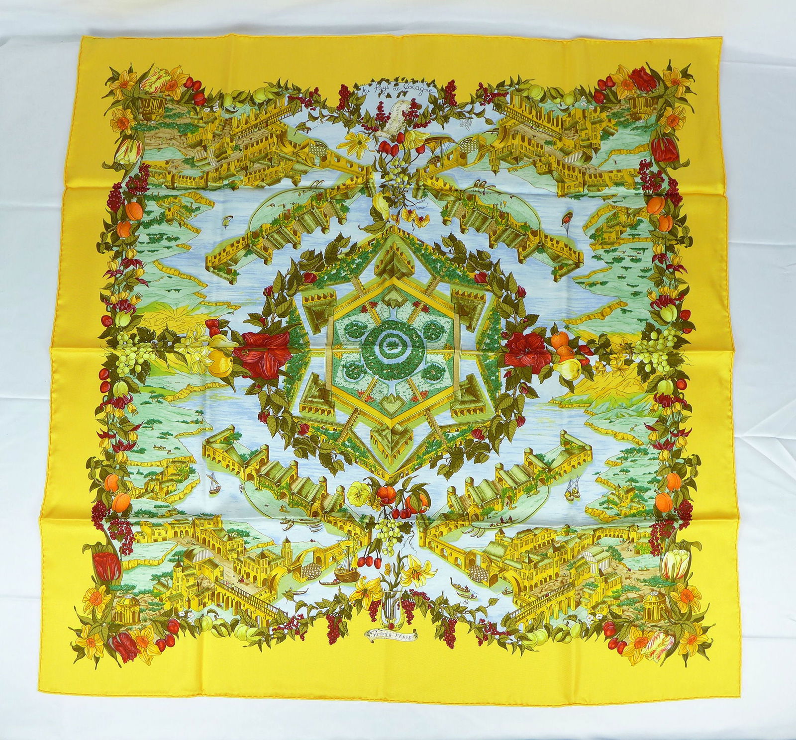 Vintage Hermes Paris Silk Scarf "Au pays de Cocagne" with box: This is a classic 90cm Carre Hermes Silk Scarf made in Paris dating from the later 80's or 90's. Titled "Au pays de Cocagne" and is decorated with an imaginary depiction of "the Land of plenty" saying