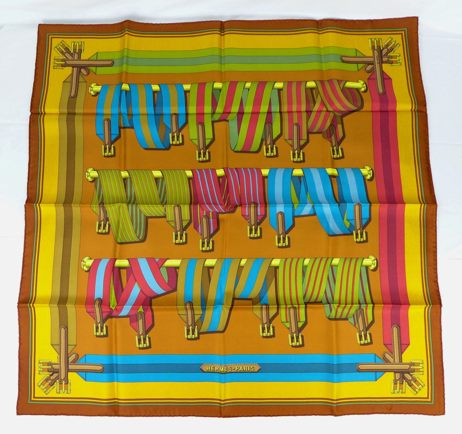 Vintage Hermes Paris Silk Scarf "Sangles" with box: This is a classic 90cm Carre Hermes Silk Scarf made in Paris dating from the later 80's or 90's. Titled "Sangles" and is decorated with group of multicolor hanging and draped equestrian belts buckles.