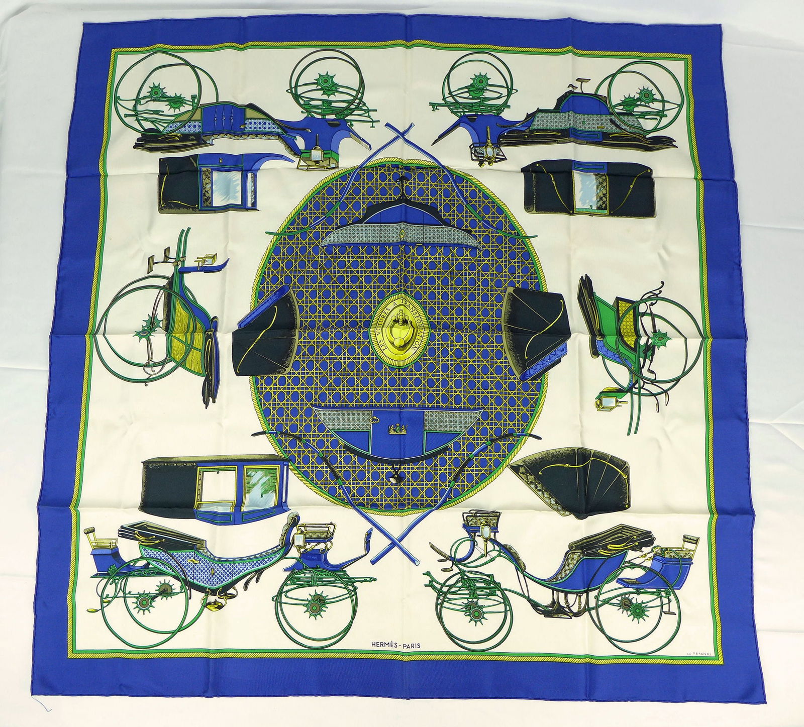 Vintage Hermes Paris Silk Scarf "Les voitures a transformation" with box: This is a classic 90cm Carre Hermes Silk Scarf made in Paris dating from the later 80's or 90's. Titled "Les voitures a transformation" and is decorated with a images of various horse carriages and th