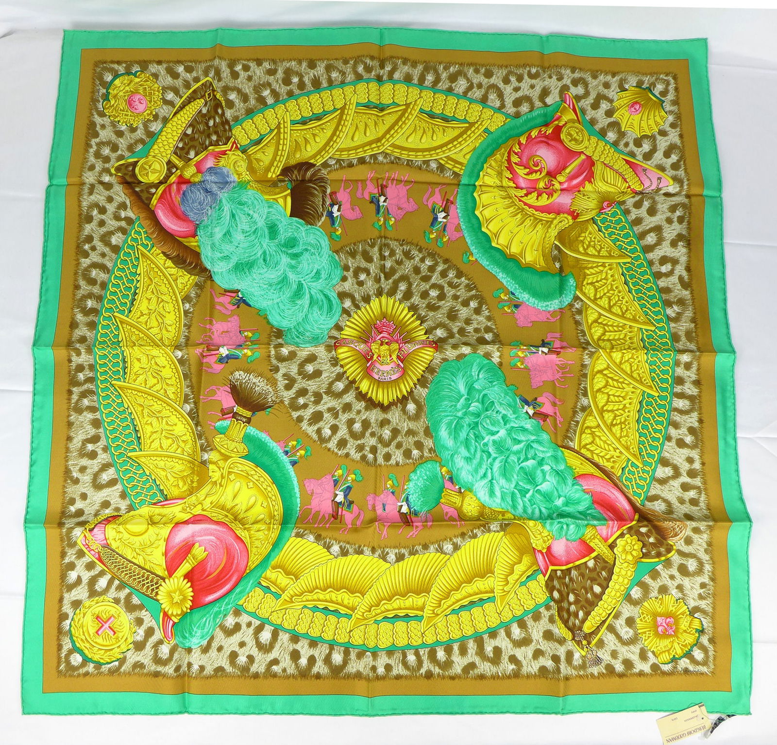 Vintage Hermes Paris Silk Scarf "Casques et plumets" new with tags ,with box: This is a classic 90cm Carre Hermes Silk Scarf made in Paris dating from the later 80's or 90's. Titled "Casques et plumets" and is decorated with a 4 large ornamental helmets with a procession of sol