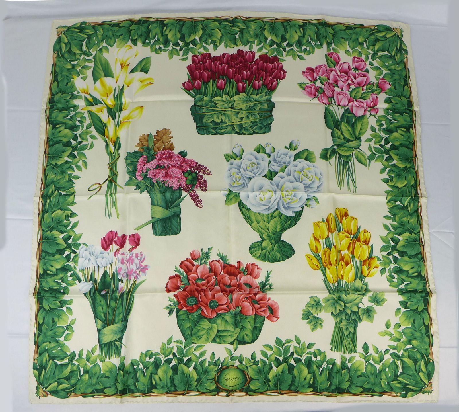 Vintage Gucci Italy Silk scarf New with tags and box "Flower Bouquets": This is a Gucci Silk Scarf made in Italy dating from the 1990's early 2000's. Decorated with multiple bouquets of flowers wrapped in leaves surrounded by a leaf entwined border. In new condition with