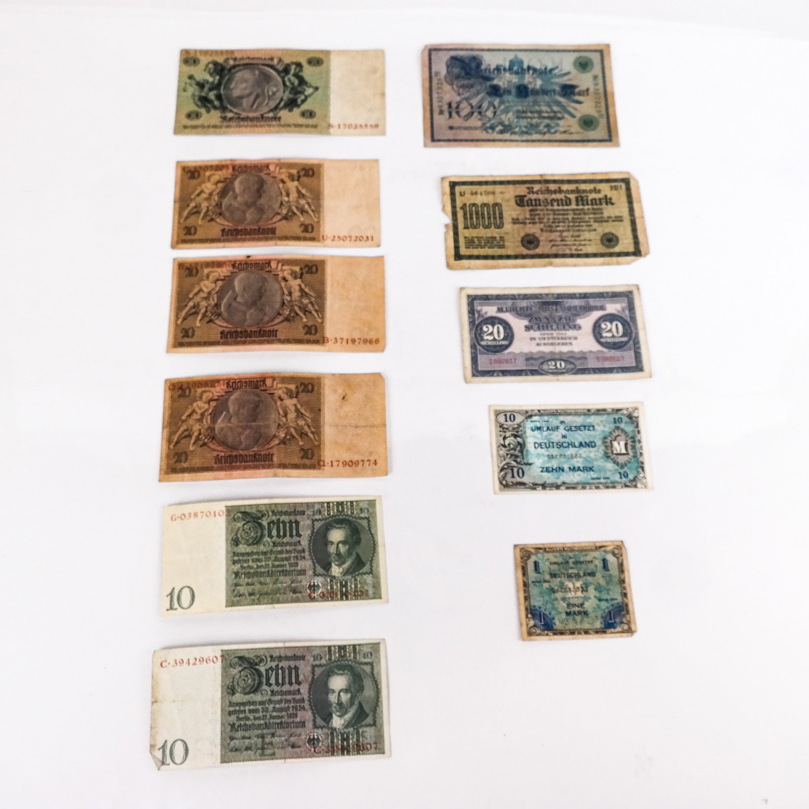 Collectible German & Austrian Paper Currency Group: Collectible obsolete German and Austrian paper currency group, first half 20th century, including WWII-era marks and schilling. In good to damaged condition (as pictured).
