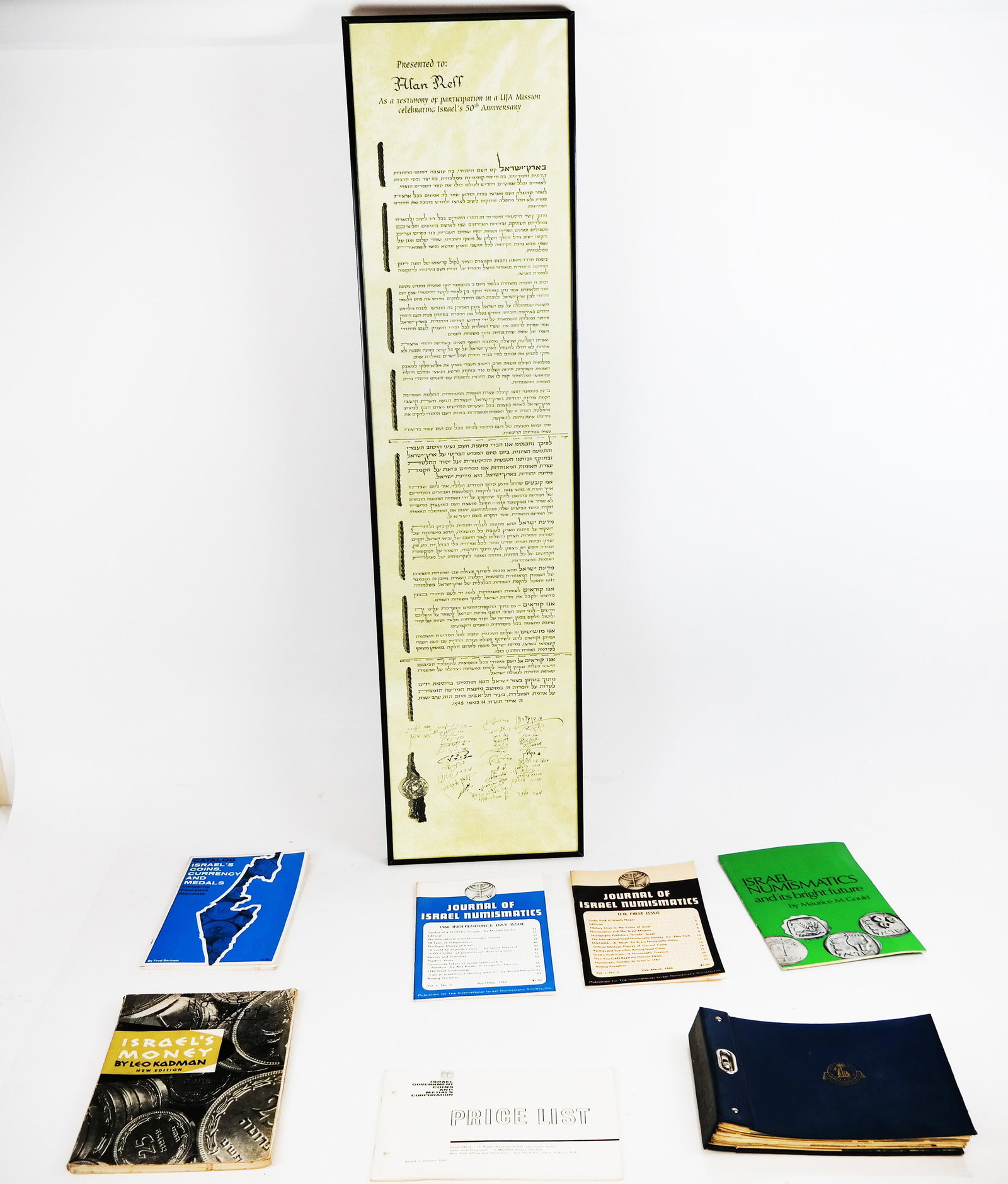 Israel: Group of Ephemera & Collectibles: Group of Israeli ephemera and collectibles, including a presentation commemorating the 50th Anniversary and books on coins and medals. [Largest: 36" x 9"].