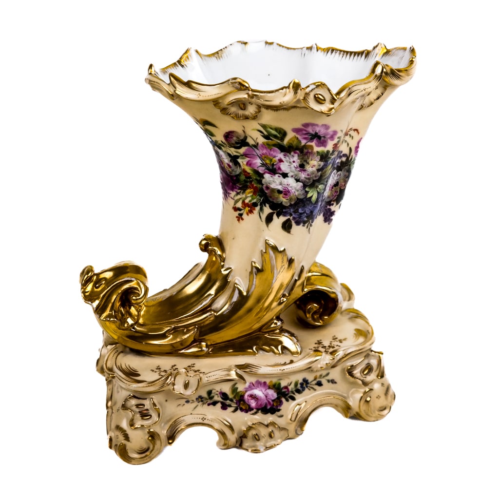 Paris Porcelain Cornucopia Vase: Paris porcelain cornucopia vase, the cream body decorated with blooming flowers, embellished with gilt, the base marked. [9" H x 7 1/8" W]. Loss to some gilding.