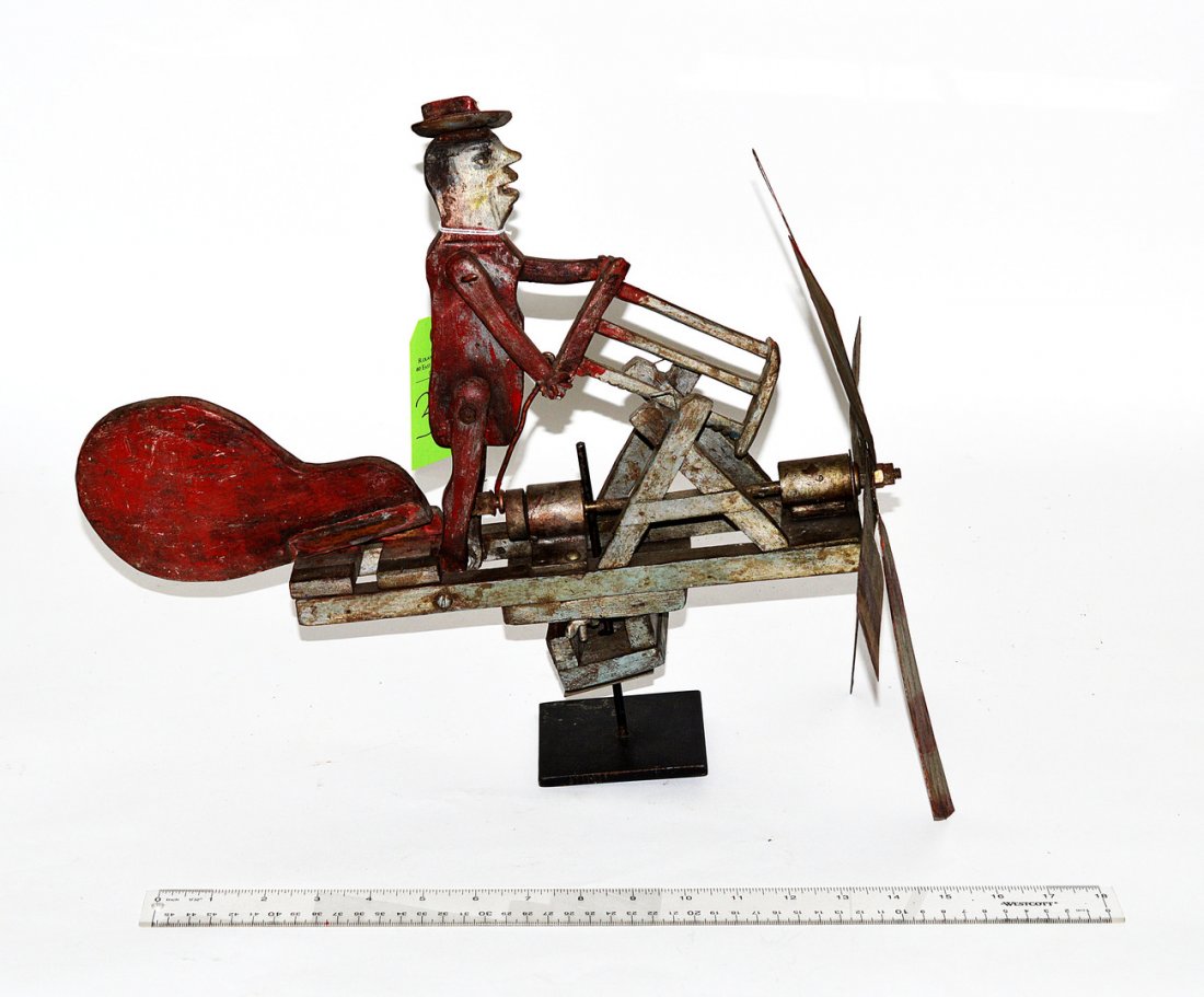 Folk Art Whirly Gig Man with Saw: Painted wood figural whirly gig of a man sawing wood with tin blades. As is. 15" H x 16" L.