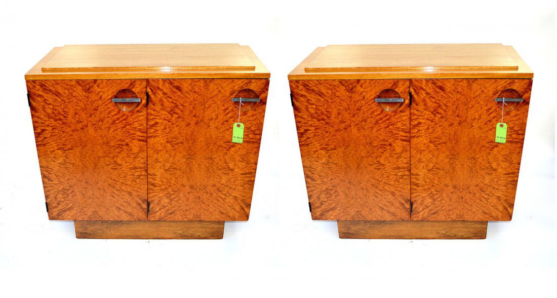 Pair of Gilbert Rohde Cabinets: Pair of server cabinets by Gilbert Rohde, circa 1930, in lacquered mahogany and burl doors with chrome pulls, single interior shelves. Originally designed for Herman Miller. 36" L x 16 3/4" D x 33 1/4