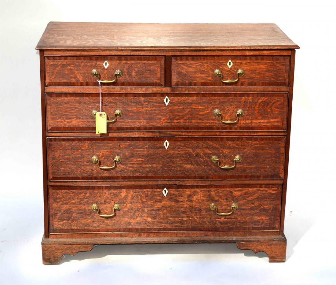 Oak Five Drawer Chest: Oak chest with five drawers, banded top and ivory escutcheons. 20 1/4"D x 38"L x 34 1/2"H. Some scratches and wear with age.