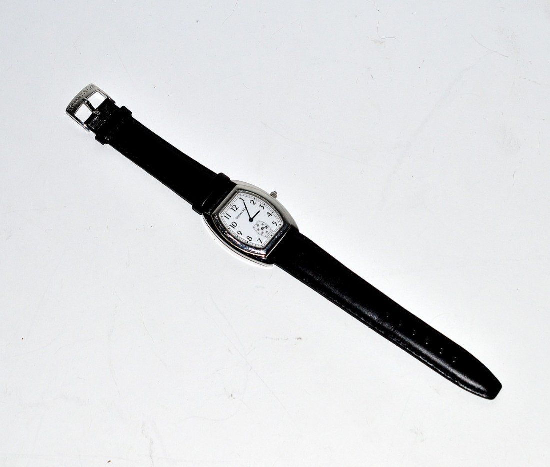 After Tiffany & Co. Men's Wristwatch: Stainless steel water resistant watch with Arabic numerals and second dial. Bears Tiffany & Co. black leather band. Needs repair.