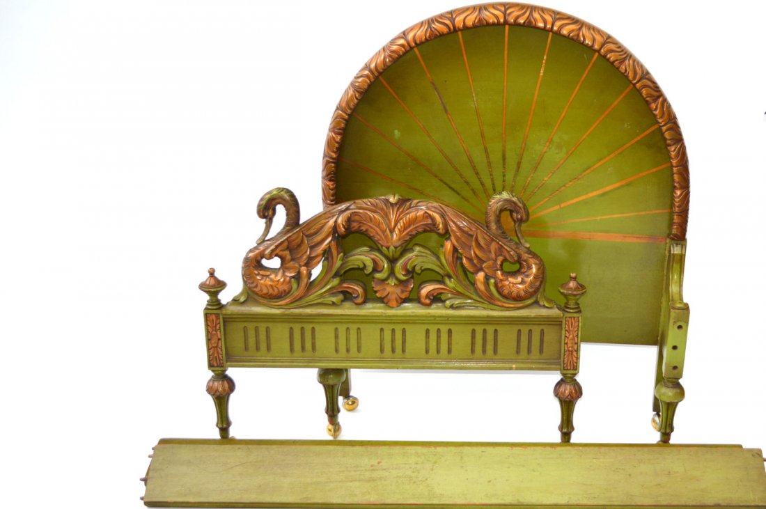 Art Deco Child's "Swan" Bed: Green and gold painted carved wood bed [no rails]. Footboard features stylized acanthus flanked by two swans, headboard bears starburst design. Headboard: 37 1/2" W x 46 1/2" H; Footboard: 38" W x 28