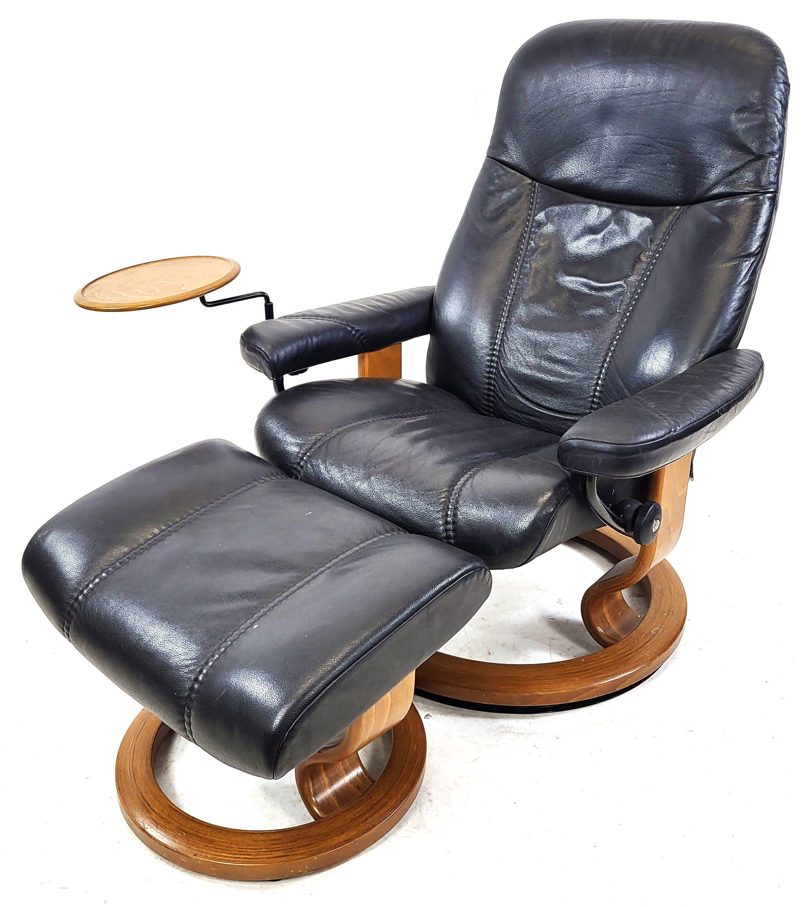 Modern Black Leather Lounge Chair & Ottoman: Modern black leather lounge chair with swivel tray, and ottoman. [Chair: 40" H x 29" W x 29" D; Ottoman: 13" H x 26" W x 17" D].