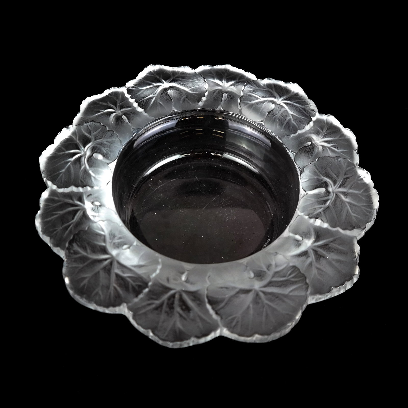 Lalique French Glass "Honfleur" Bowl: Lalique French glass bowl with relief details of leaf motifs, bearing etched signature to base. [2 1/2" H x 8 5/8" Diam.]. Light scuffs and residue.