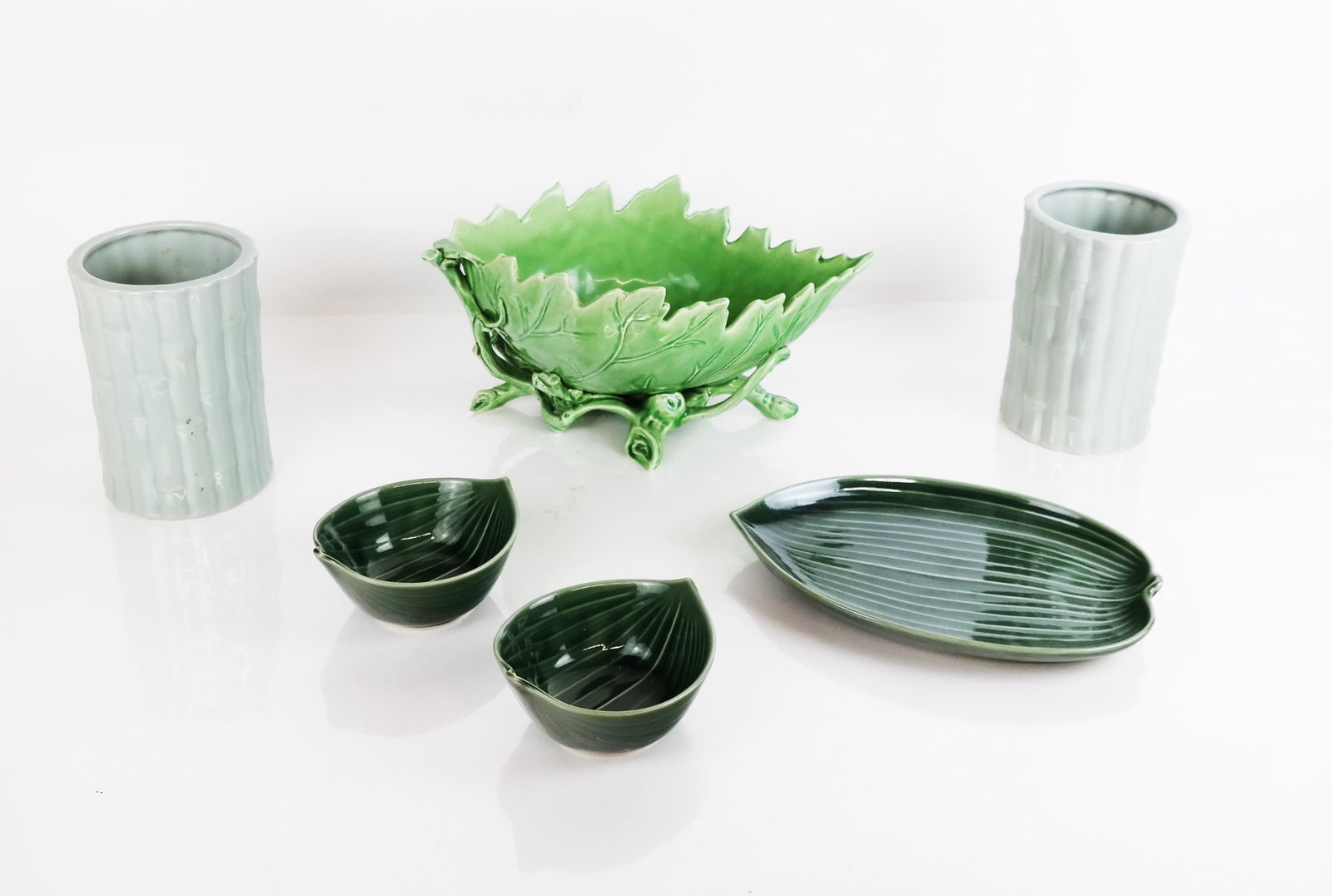 Assembled Group of Naturalistic Tableware: Assembled group of naturalistic tableware, including a pair of bamboo-motif vases, a cabbage leaf-motif bowl and banana leaf tray and bowls. [Bowl: 5 3/4" H x 11 3/4" W x 7" D]. Residue, marks and wea