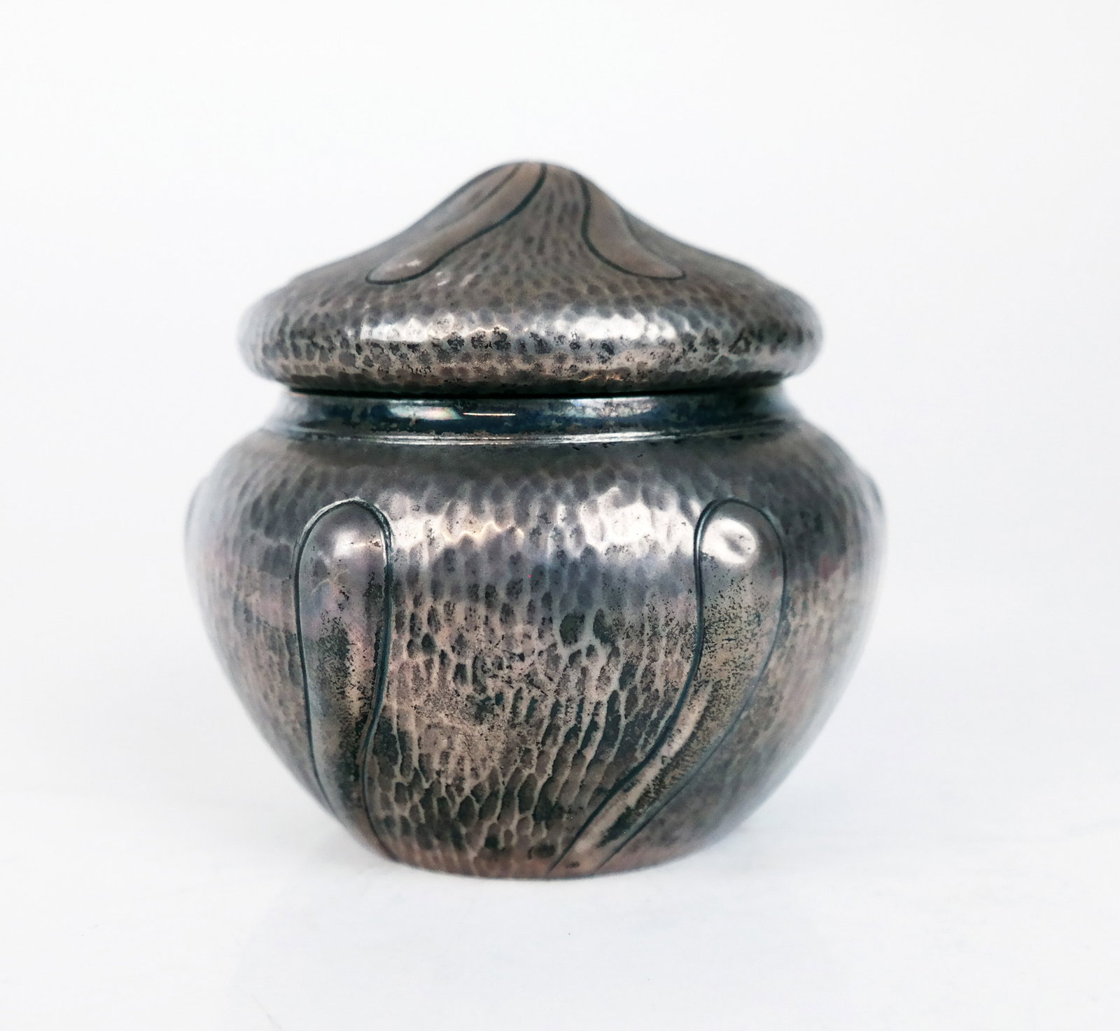 English Silver Covered Bowl: English silver covered bowl by Stokes & Ireland, Ltd., London, 1928, in the Arts & Crafts style, the hammered circular body an lid with sunray motif, the interior with vermeil. 5.10 ozt. [4" Diam.].