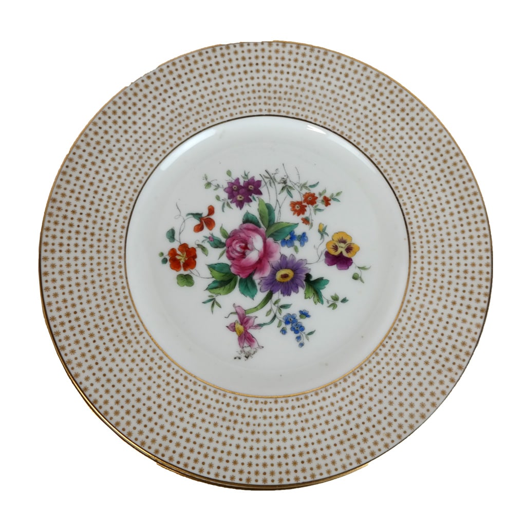 Cauldron Ltd. Porcelain Dessert Plates (12): Twelve (12) Cauldron Ltd. English porcelain dessert plates, retailed by W.H. Plummer & Co., the cream ground with star and dot border centering a bouquet of spring flowers. [8" Diam.].