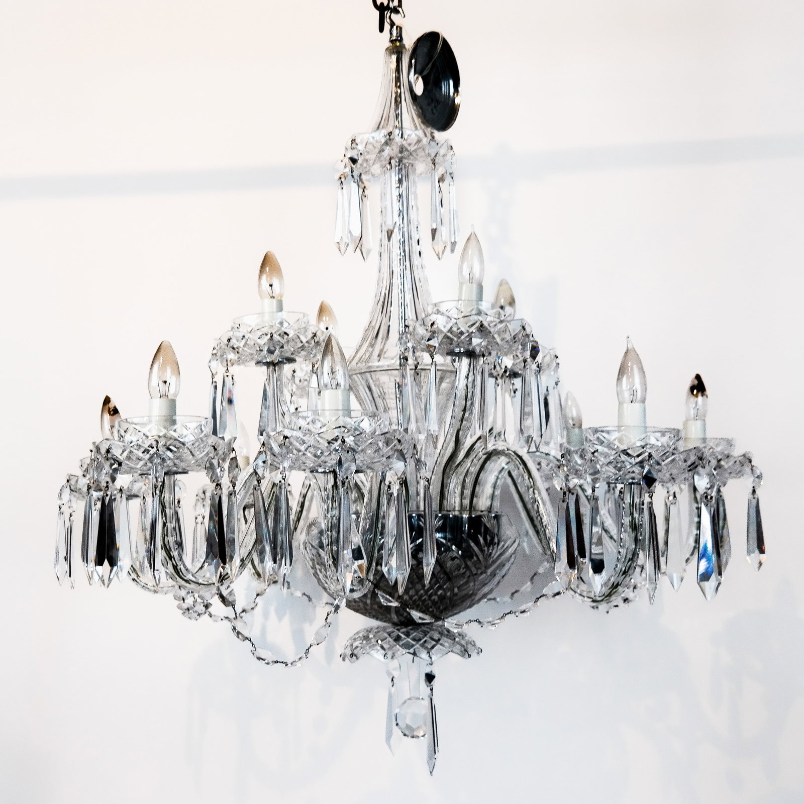 Waterford Cut Glass 12-Light Chandelier: Waterford Irish cut glass 12-light chandelier, overall with faceted prisms, in the Georgian manner, bearing marks to some bobeches. [40" H x 38" Diam.]. Lacking a few prisms.