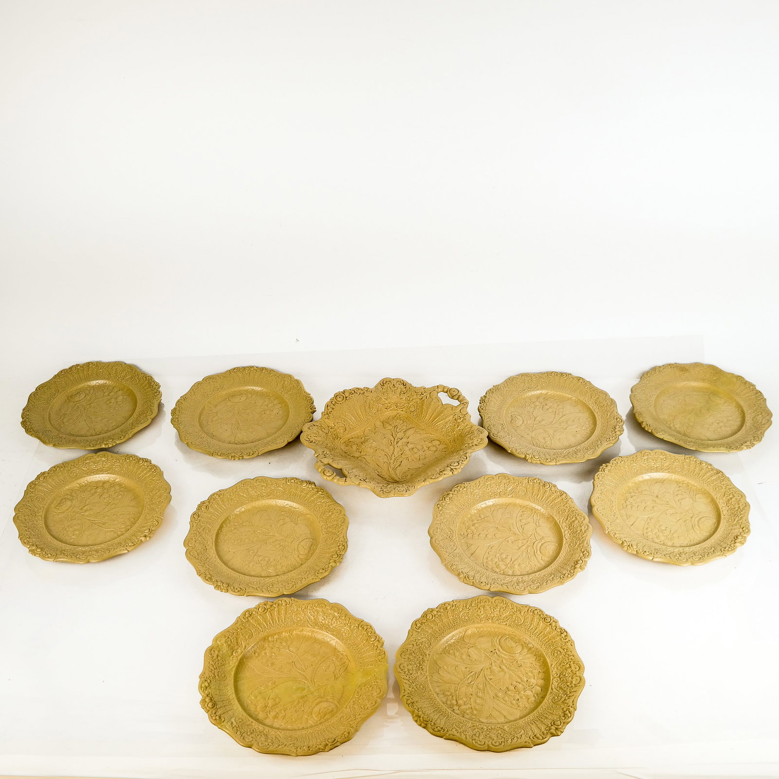 Set of Vintage Creamware Plates (10): Set of ten (10) vintage creamware plates, probably Ridgway, with bas-relief drabware details, together with a sandwich platter. [8 7/8" Diam.].