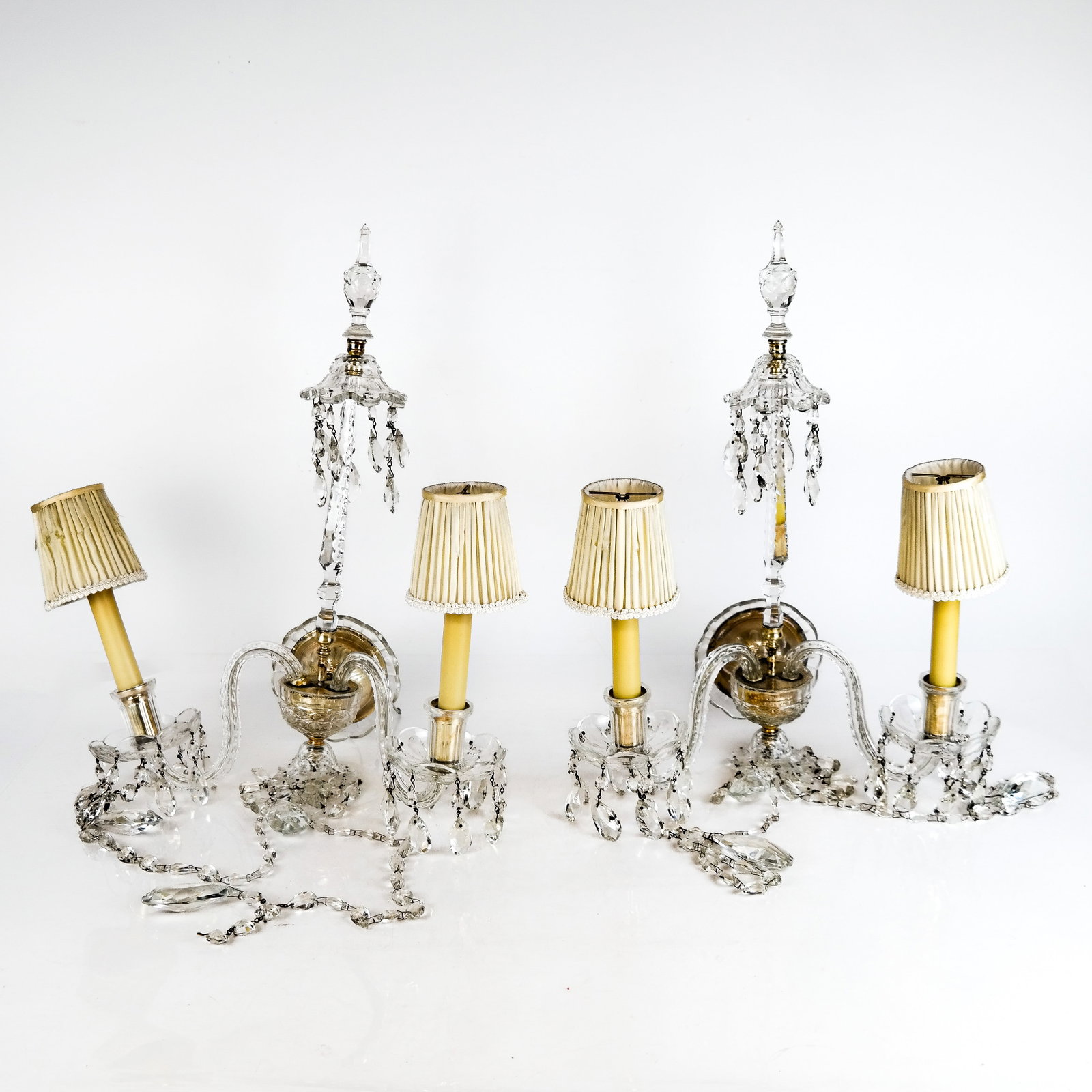 Georgian-Style Cut Glass Sconces: Georgian-style cut glass sconces in the manner of Waterford, the girandoles with unusual carousel finial and faceted cut glass pendant prisms, unmarked. [19" H x 15" W x 6" D]. Some prisms missing; sh