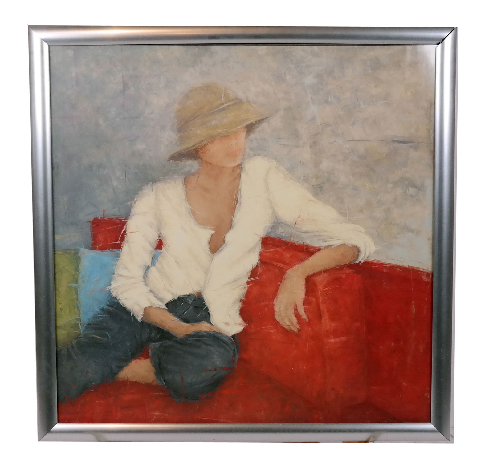 Print of a Seated Woman: Print of a seated woman wearing a hat, on a red sofa. [Frame: 26" x 26"].
