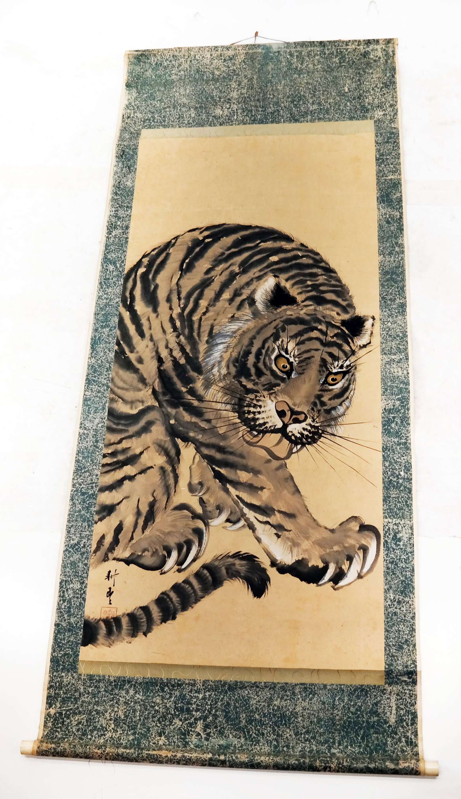 Chinese Ink and Wash Scroll: Chinese ink and wash scroll depicting a tiger grooming. [28" W].
