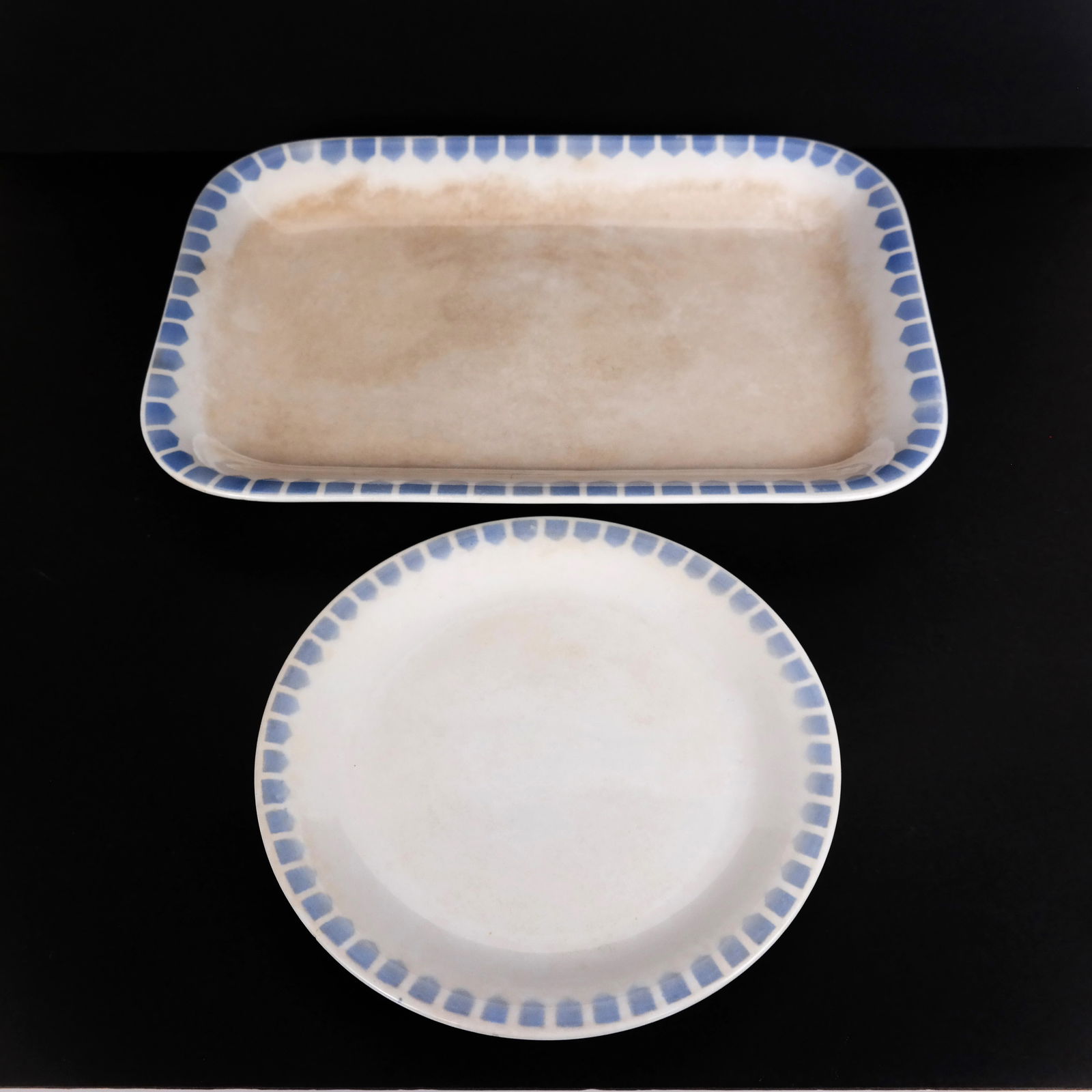 Therese Trethon, School of Koloman Moser Porcelain: Therese Trethon (Austrian, 1879-1957) Arts & Crafts, Vienna, porcelain, comprising a rectangular platter [15 5/8" x 10 5/8"], and a plate [9 5/8" Diam.], with blue and white geometric border, marked t