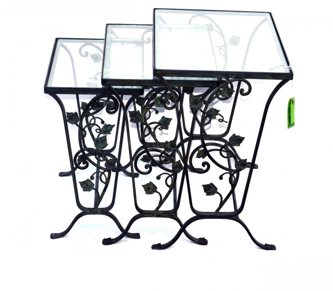 Set of Three Green Patinated Steel Nesting Tables: Glass top tables, all bear scrolling leafy tendril accents. Largest: 24 1/2" x 14 1/2" x 20 1/2". In good condition.