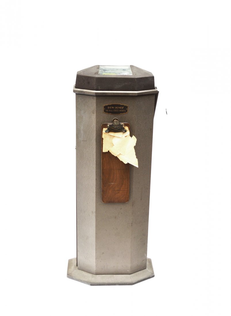 Dow Jones Wall Street Journal Tickertape Machine: Machine-Age octagonal enameled steel ticker tape machine with lower cabinet concealing mechanism. 17 1/2" W x 10 1/2" D x 48" H. Accompanied by original oblong clipboard.