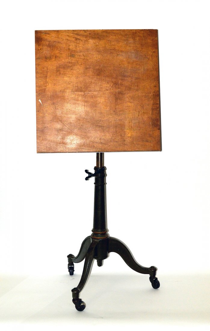 19th Century Drafting Table: Cast iron fully adjustable tripod base drafting table on castor feet. Top: 24" sq. Height: 32" to 44". Complete