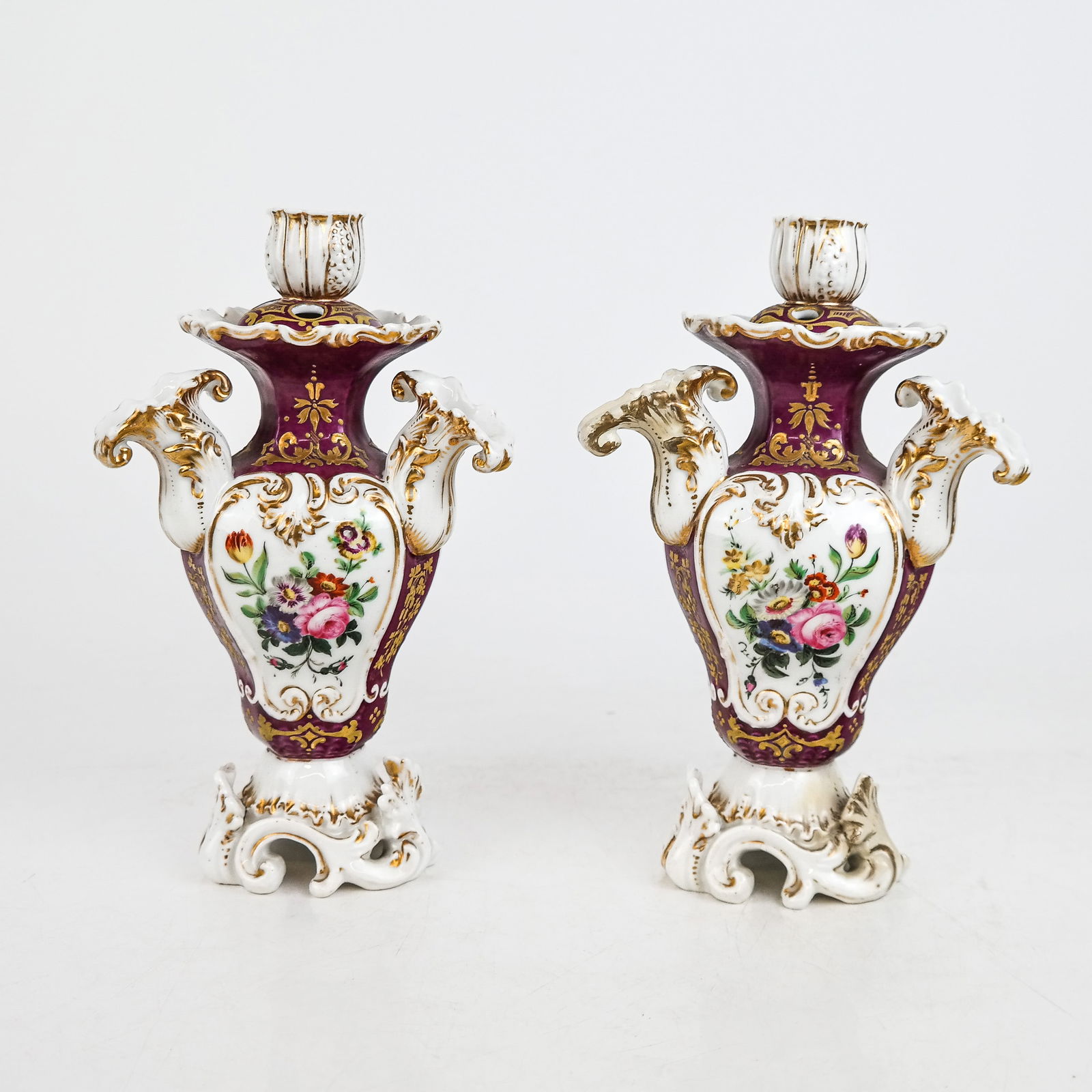 Pair of Jacob Petit Porcelain Candlesticks: Pair of Jacob Petit porcelain candlesticks. [8" H x 5" Diam.]. One restored. Condition reports and requests for additional photos cannot be accepted on this lot, please bid accordingly. This is not an