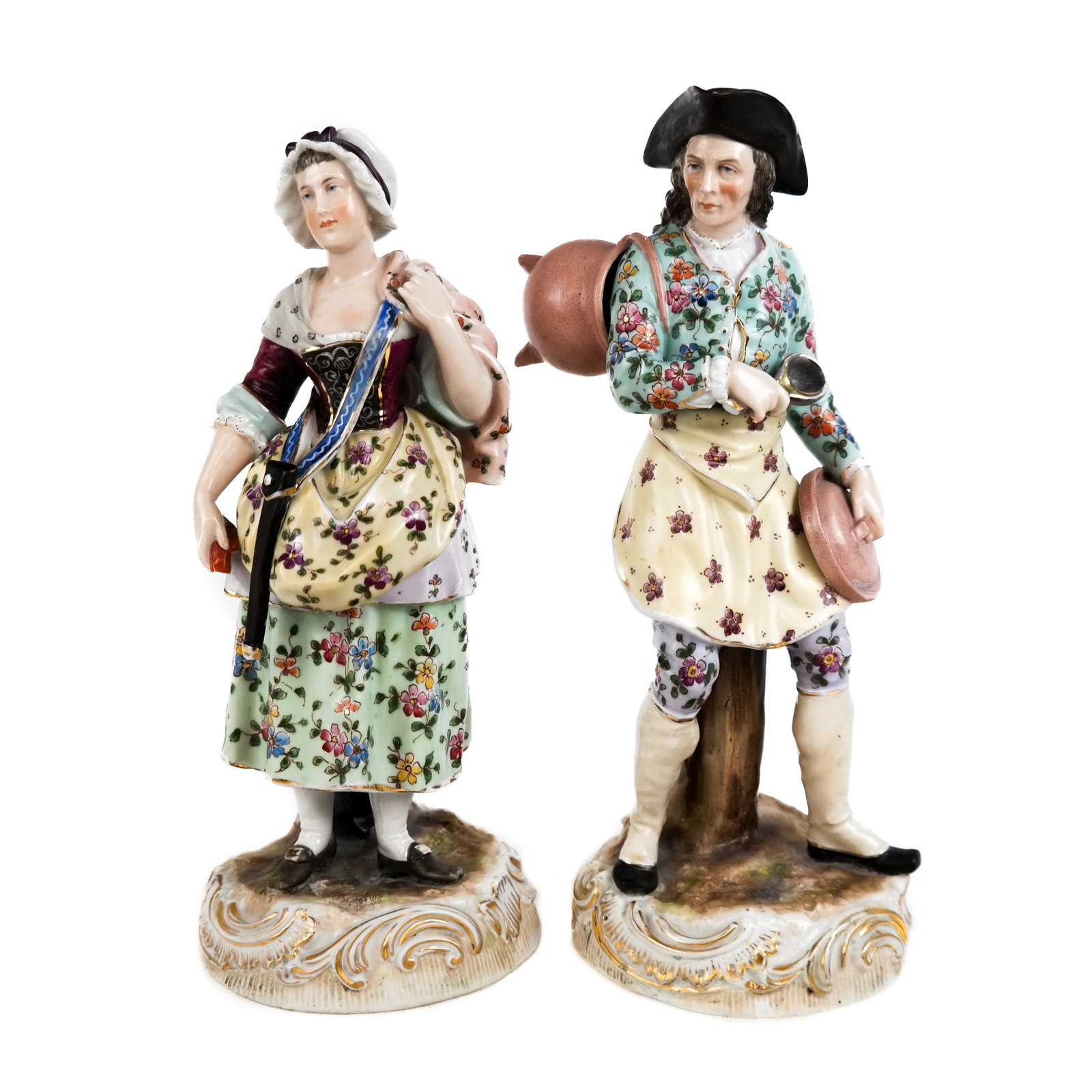 Pair of Decorated Porcelain Sculptures: Two sculptures, of a man and a woman. [10 1/2" H x 4" Diam. (base)]. Hand of woman damaged. Condition reports and requests for additional photos cannot be accepted on this lot, please bid accordingly.
