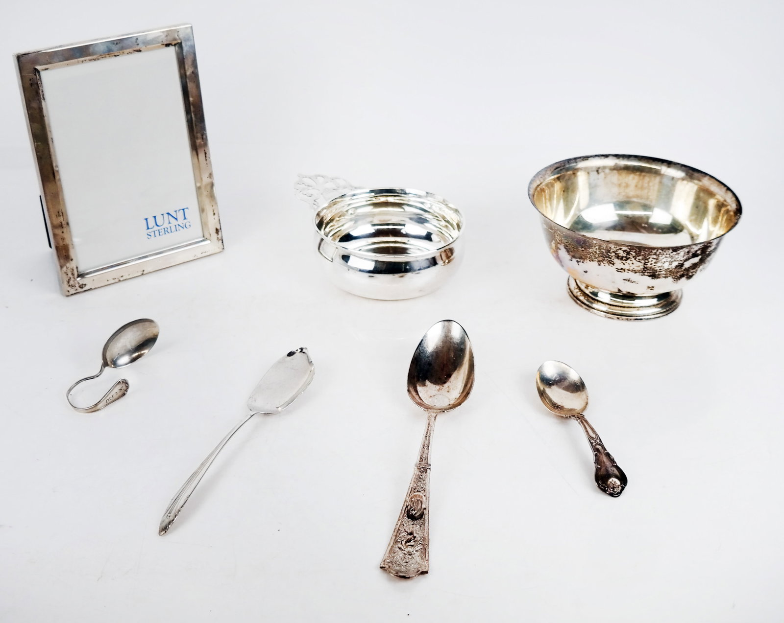 7 Assorted Sterling Silver Articles: Seven (7) assorted sterling silver articles, comprising a Lunt frame, Revere-style bowl, wine taster and 4 spoons. 17.2 ozt. [Bowl: 3" H x 6" Diam.].