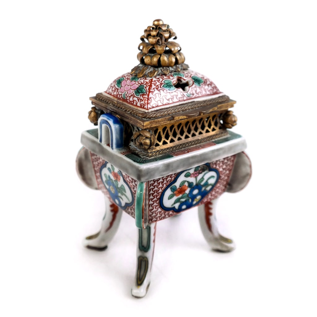 Asian Porcelain and Gilt Metal Censer: Asian porcelain and gilt metal censer, probably Japanese, 19th/20th century, the pierced gallery with rosettes and foliate finial. [5" H x 2 3/4" W x 2 3/8" D]. Base with age/stress cracks; residue to