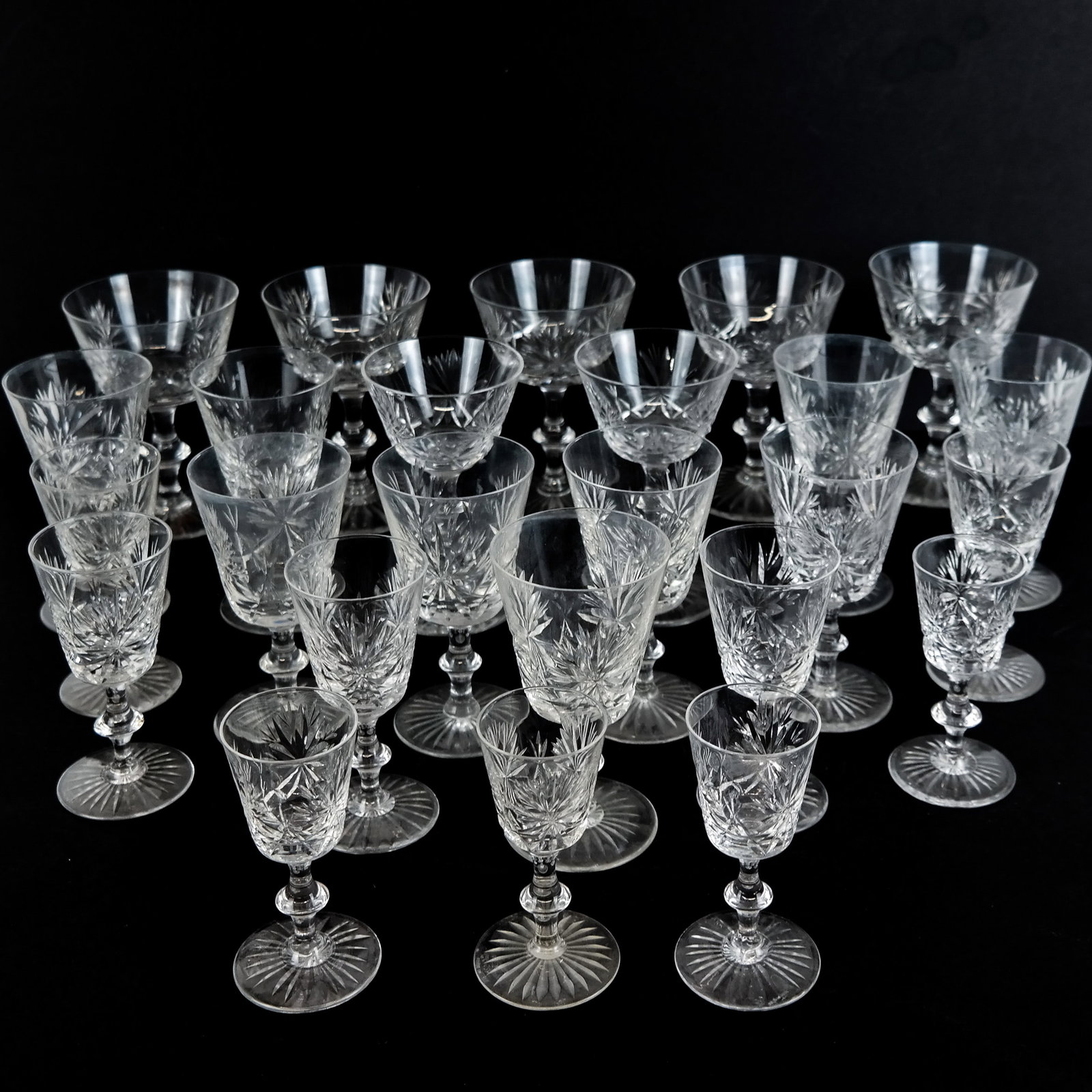 Edniburgh Crystal Partial Stemware: Group of Edinburgh crystal stemware in the "Star of Edinburgh" pattern, comprising 8 cordials [4" H], 5 white wine glasses [4 3/8" H], 7 water glasses [5" H], and 7 champagne glasses [5 1/4" H], marke